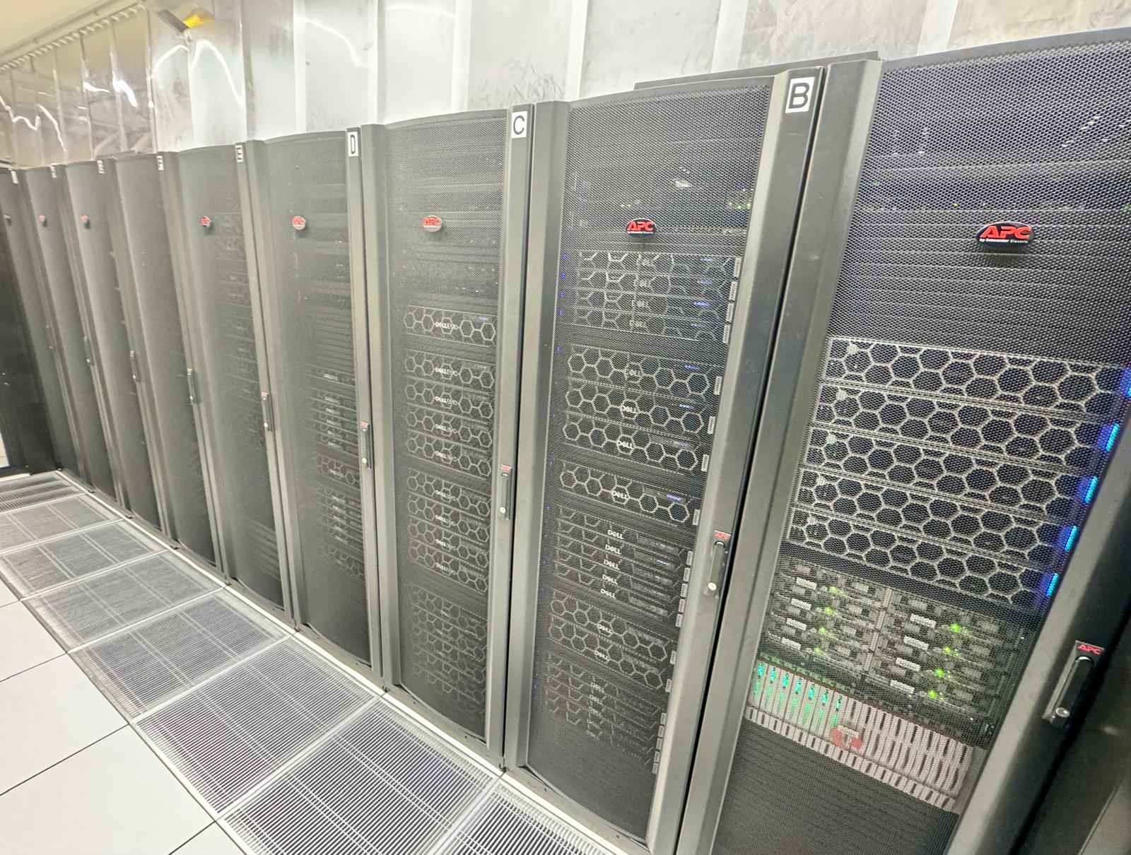 The front of the Aoraki cluster: a row of black server cabinets, lettered A to F, seen down the cold aisle.